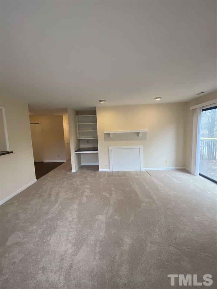 5820 Pointer Drive, Unit 202 Raleigh, NC 27609 - Photo 14 of 20 a view of empty room with a fireplace and windows