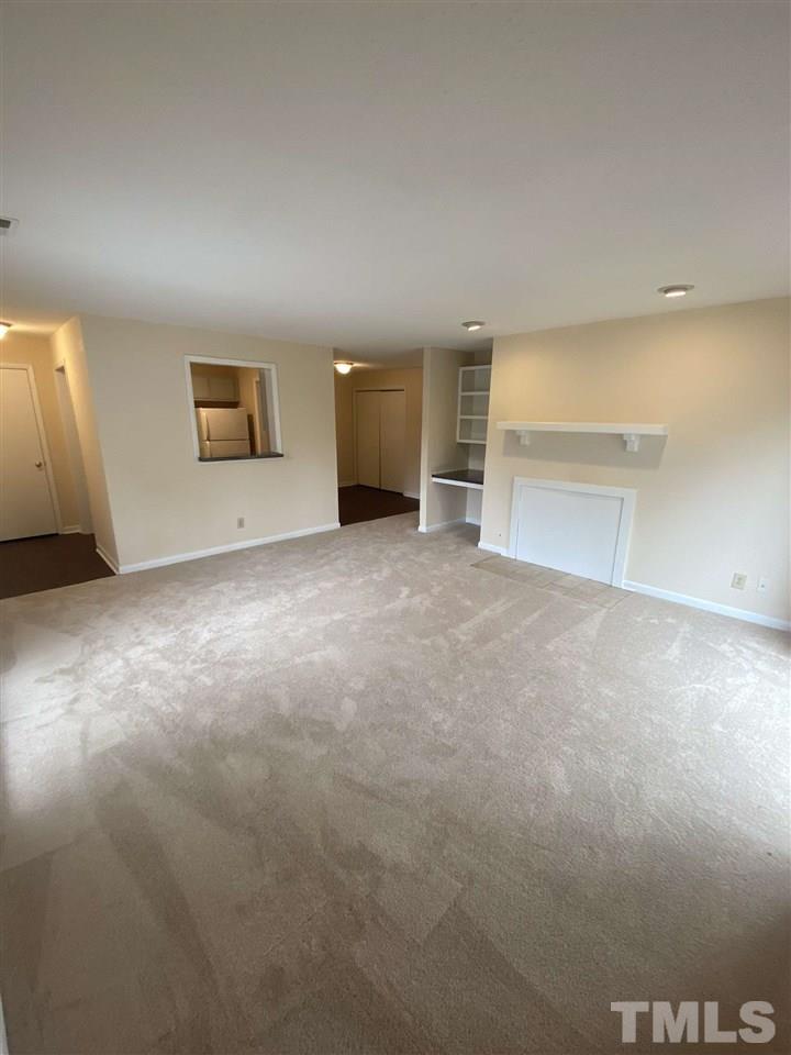 5820 Pointer Drive, Unit 202 Raleigh, NC 27609 - Photo 4 of 20 an empty room with a empty space and window
