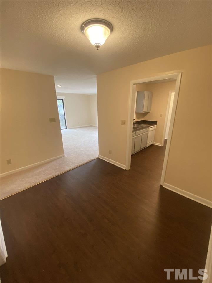 5820 Pointer Drive, Unit 202 Raleigh, NC 27609 - Photo 10 of 20 an empty room with wooden floor and windows