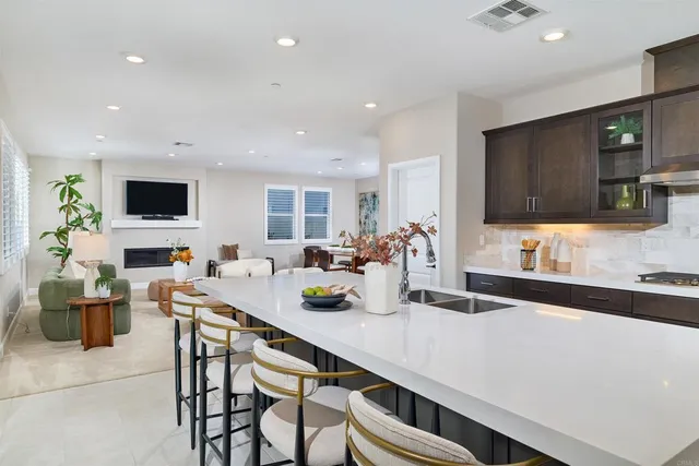 a kitchen with a table chairs stove and cabinets