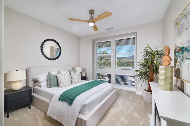 a bedroom with a large bed and a large window