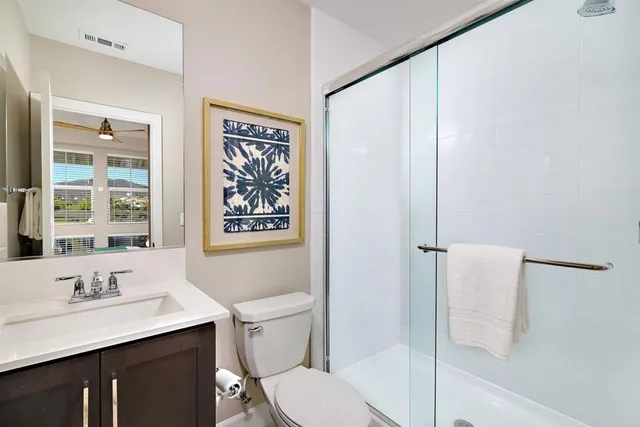 a bathroom with a sink toilet and shower