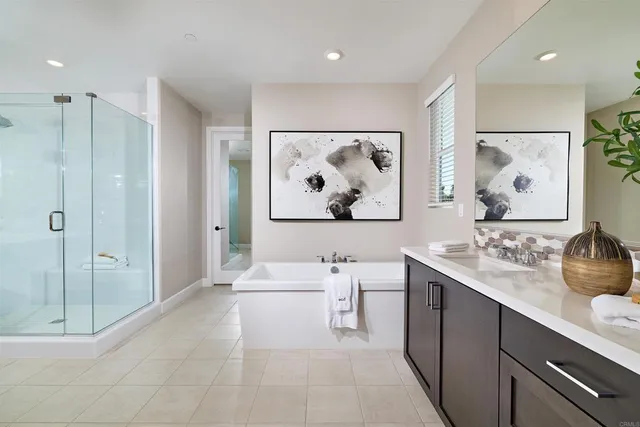 a en suite bathroom with double vanity sinks a mirror and a shower