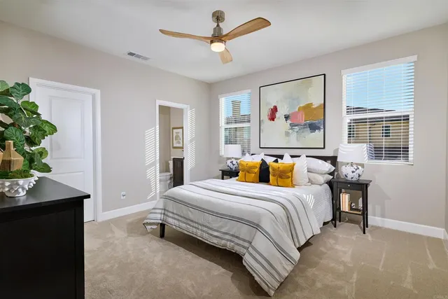 a bedroom with a bed table and a window