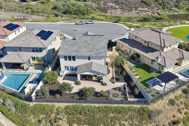 an aerial view of a house with a garden and lake view