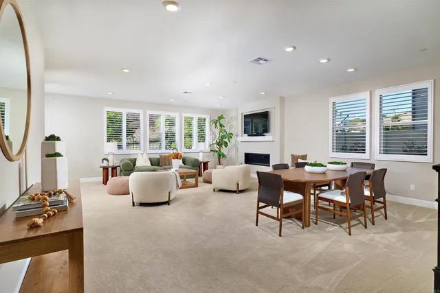 a living room with fireplace furniture and a large window