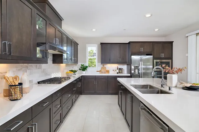 a kitchen with stainless steel appliances a sink stove and cabinets