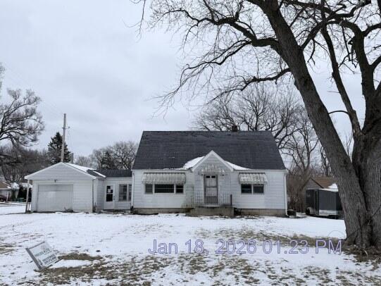 6927 Delaware Street Merrillville, IN 46410 - Photo 1 of 13 a front view of a house with a yard covered in snow