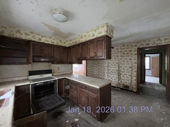 6927 Delaware Street Merrillville, IN 46410 - Photo 6 of 13 a kitchen with granite countertop a stove and a sink