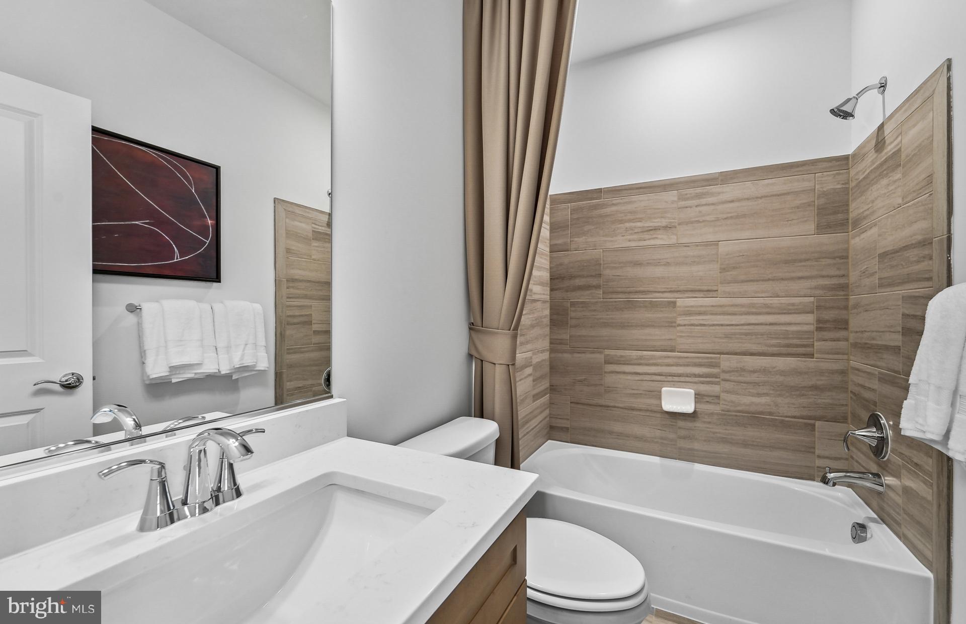 502 Crossvine Lane Laurel, MD 20724 - Photo 22 of 61 a bathroom with a granite countertop sink toilet and bathtub