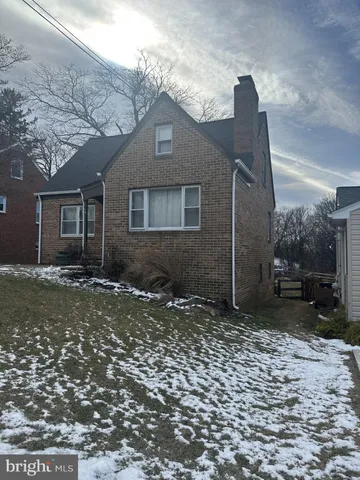 a house that has a tree in front of it