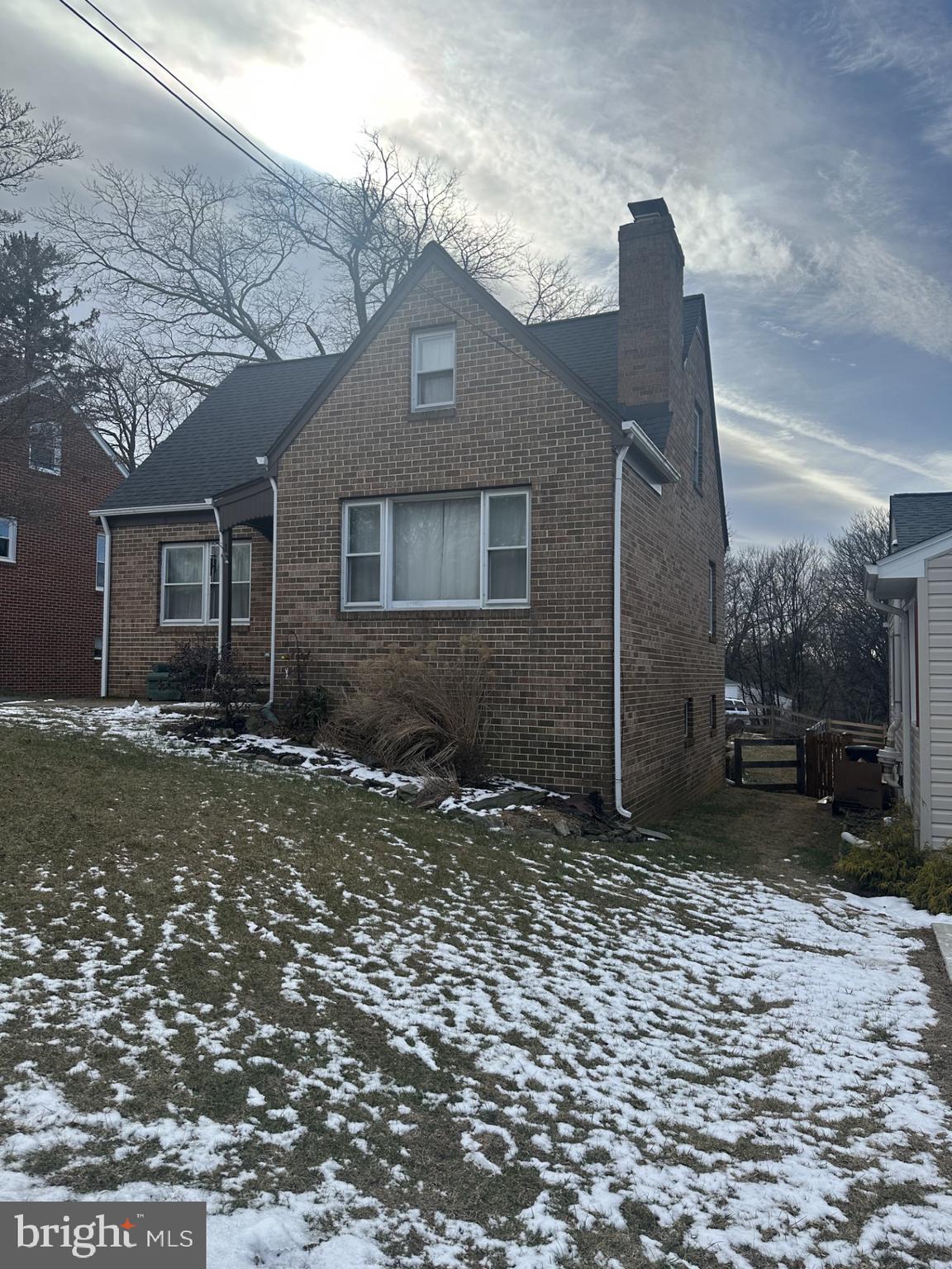 a house that has a tree in front of it