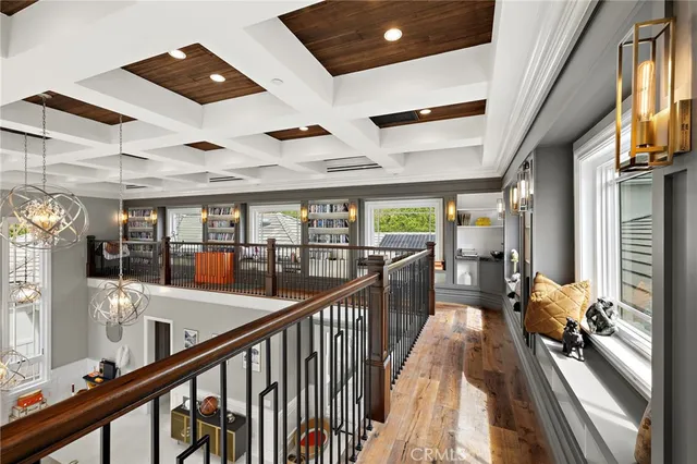 a dining room with wooden floor and stainless steel appliances