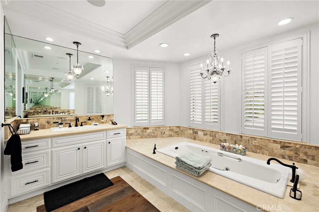 3202 Portico Del Norte San Clemente, CA 92673 - Photo 18 of 62 a bathroom with double vanity sinks a large mirror and a bathtub