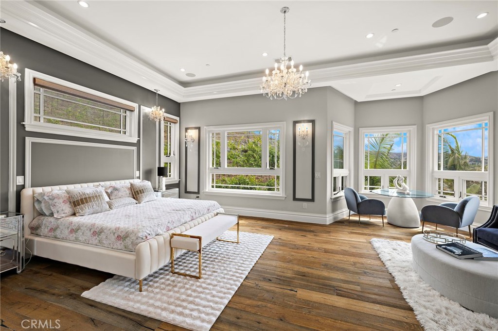 3202 Portico Del Norte San Clemente, CA 92673 - Photo 28 of 62 a spacious bedroom with a large bed a chandelier and windows