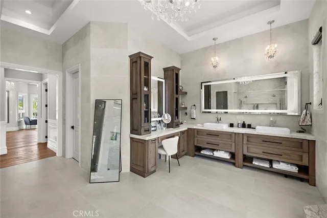 a large white kitchen with a stove a sink dishwasher and a dining table with wooden floor