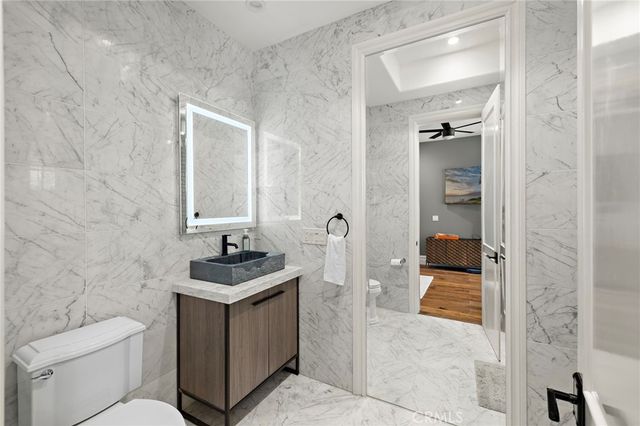 a view of a patio with couches table and chairs and potted plants