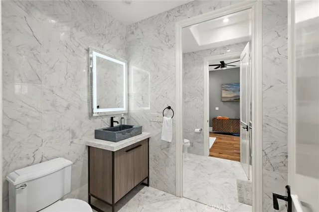 a view of a patio with couches table and chairs and potted plants