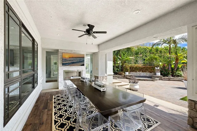a view of a patio with couches chairs and a big yard