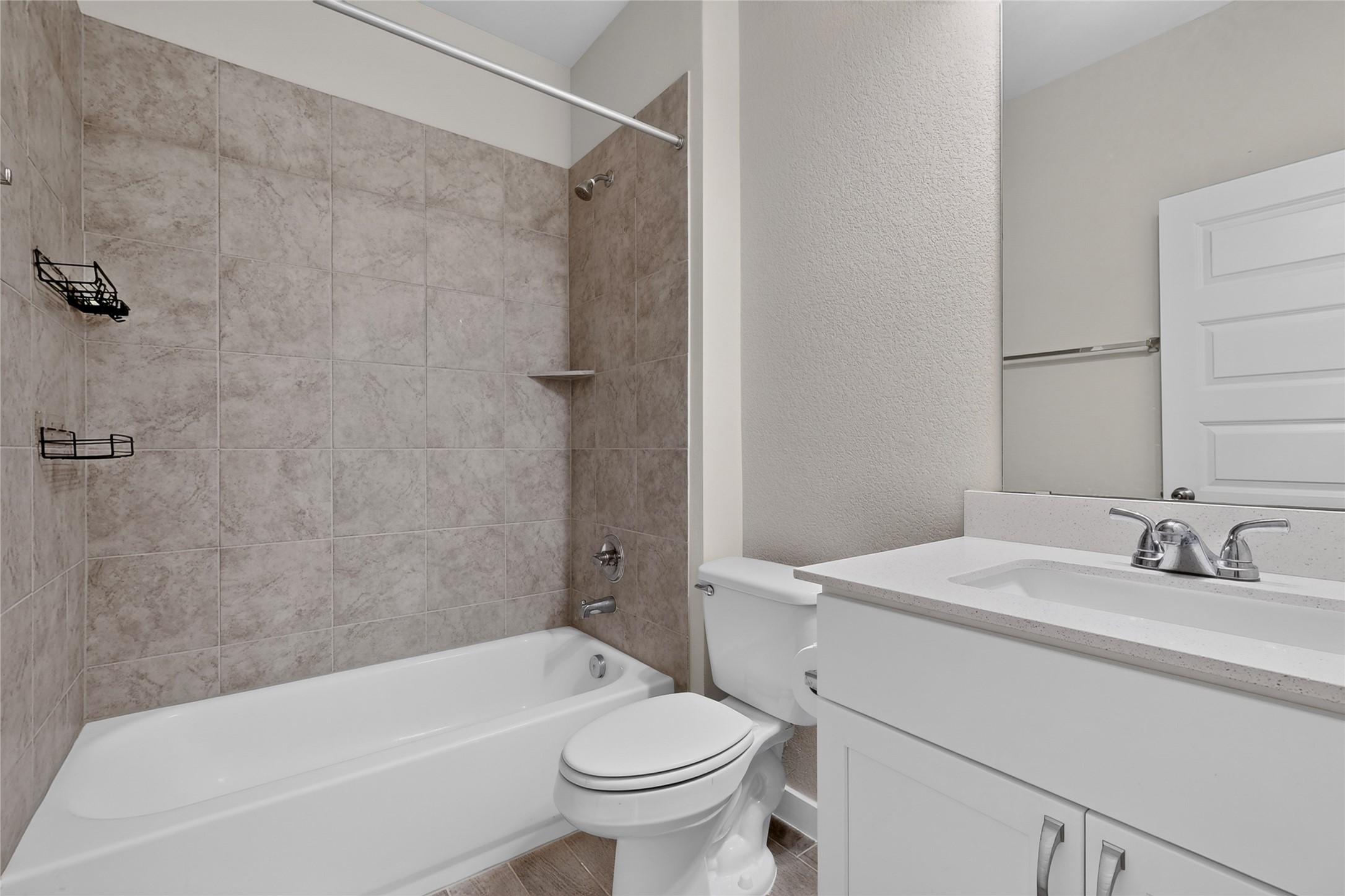 116 Appleberry Lane Elgin, TX 78621 - Photo 23 of 35 Tiled bath and shower with a sleek vanity offer contemporary comfort.