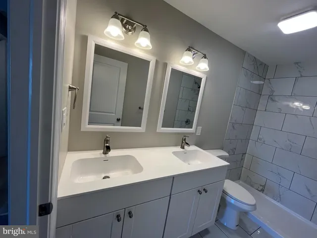 a bathroom with a sink toilet and mirror