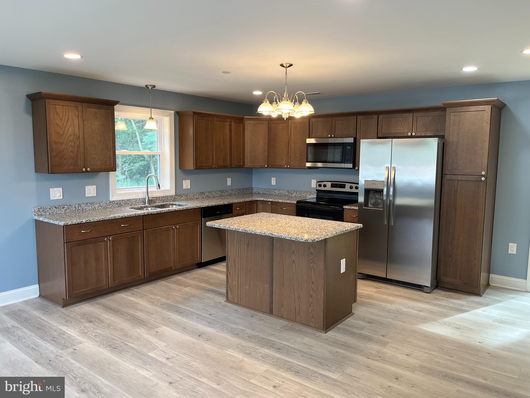 0 Will Be 11037 Bottom Road Worton, MD 21678 - Photo 2 of 32 a kitchen with stainless steel appliances granite countertop a refrigerator a sink a stove a microwave and wooden cabinets
