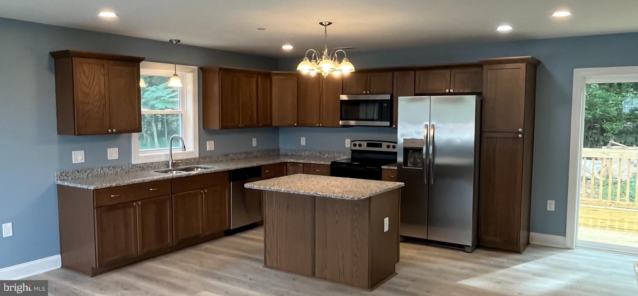0 Will Be 11037 Bottom Road Worton, MD 21678 - Photo 5 of 32 a kitchen with stainless steel appliances granite countertop a sink stove and refrigerator