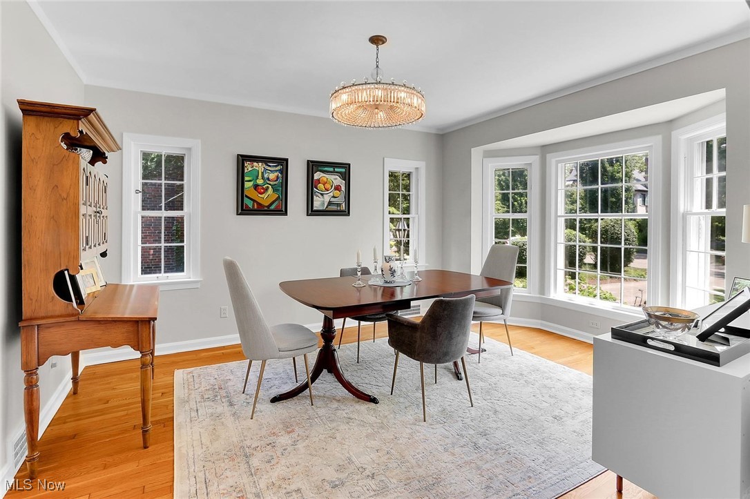 2350 Roxboro Road Cleveland Heights, OH 44106 - Photo 7 of 19 Dining space featuring healthy amount of natural light, light wood-style floors, and a chandelier