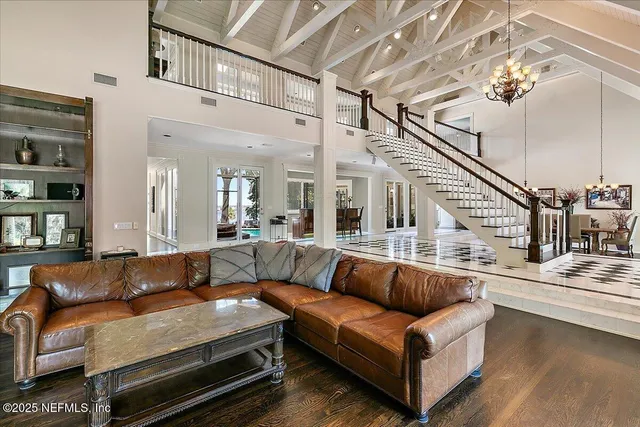 a view of a dining room with furniture and a chandelier