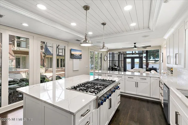 a kitchen with stainless steel appliances a sink stove and cabinets
