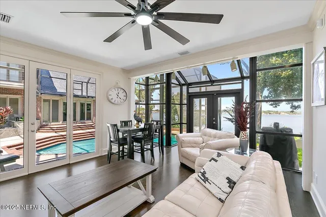 a spacious bedroom with a bed and glass window