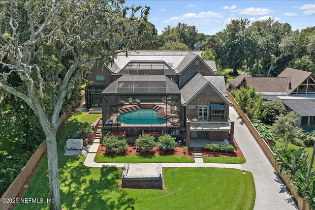 a view of a house with pool and chairs