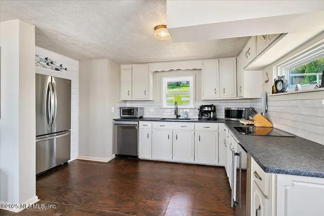 a roof deck with wooden floor and outdoor seating