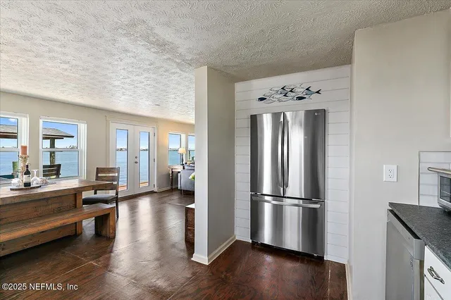 an aerial view of a house with swimming pool and lake view