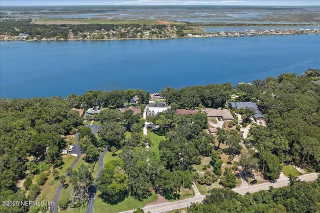 an aerial view of a house with swimming pool and garden