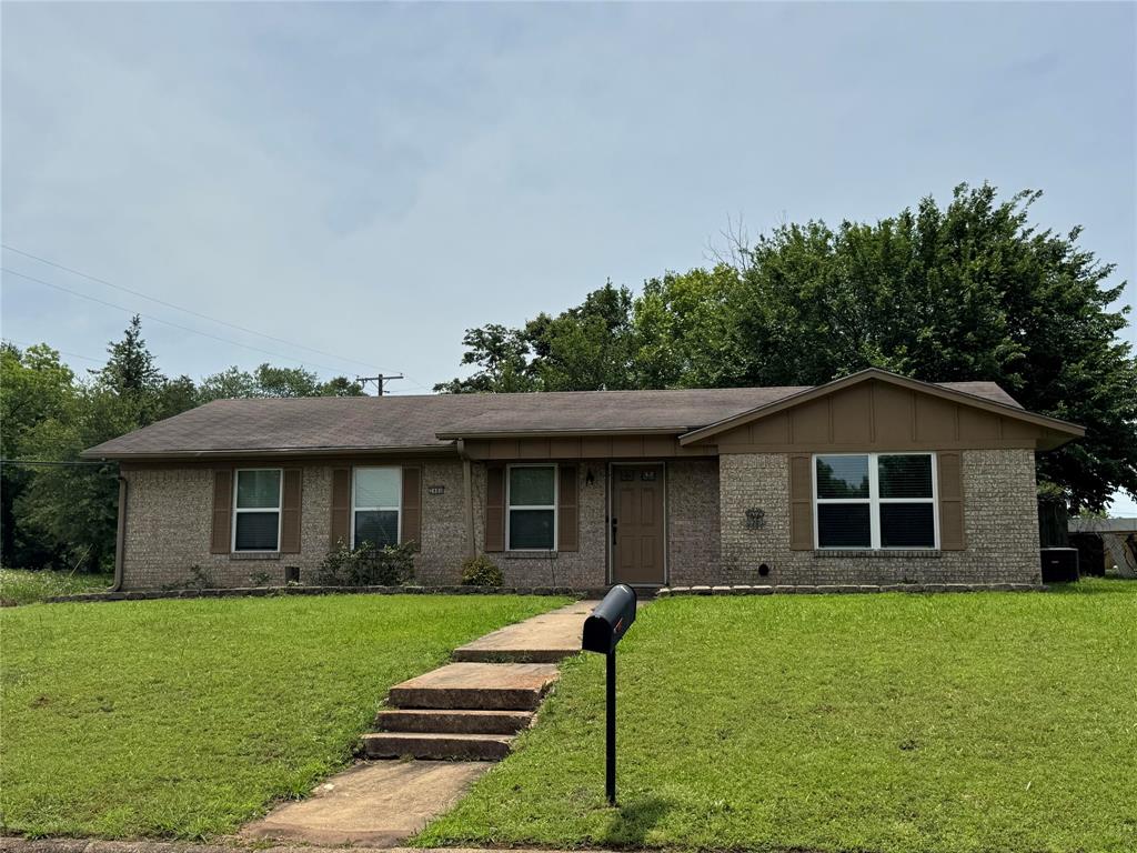4515 Southeast Loop 286 Paris, TX 75460 - Photo 30 of 37 a front view of a house with a yard