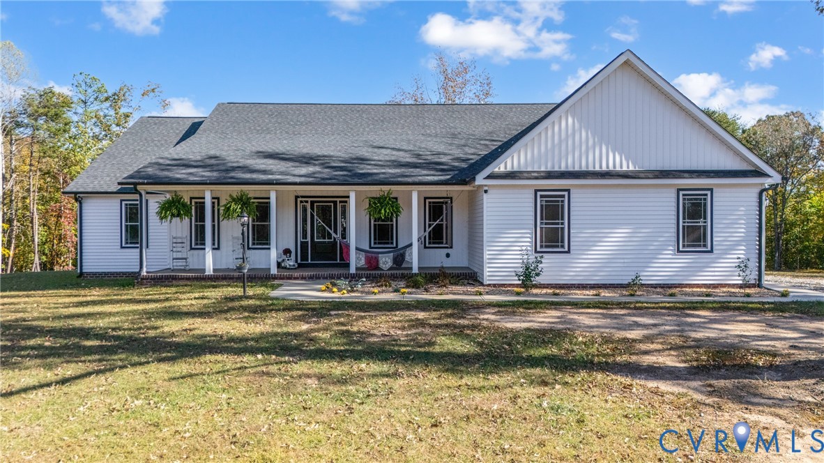 a view of a house with a swimming pool and a yard