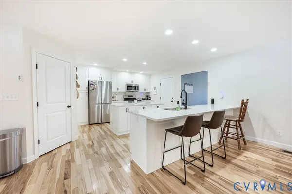 a kitchen with stainless steel appliances kitchen island granite countertop a sink and cabinets