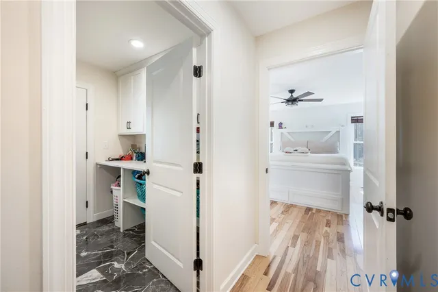 a kitchen with a refrigerator and white cabinets