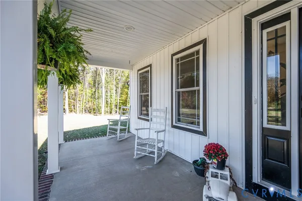 a view of an entryway with wooden floor and a potted plant