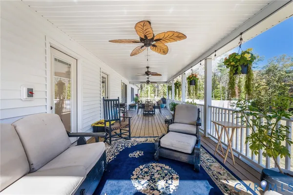 a living room with furniture a chandelier and a window