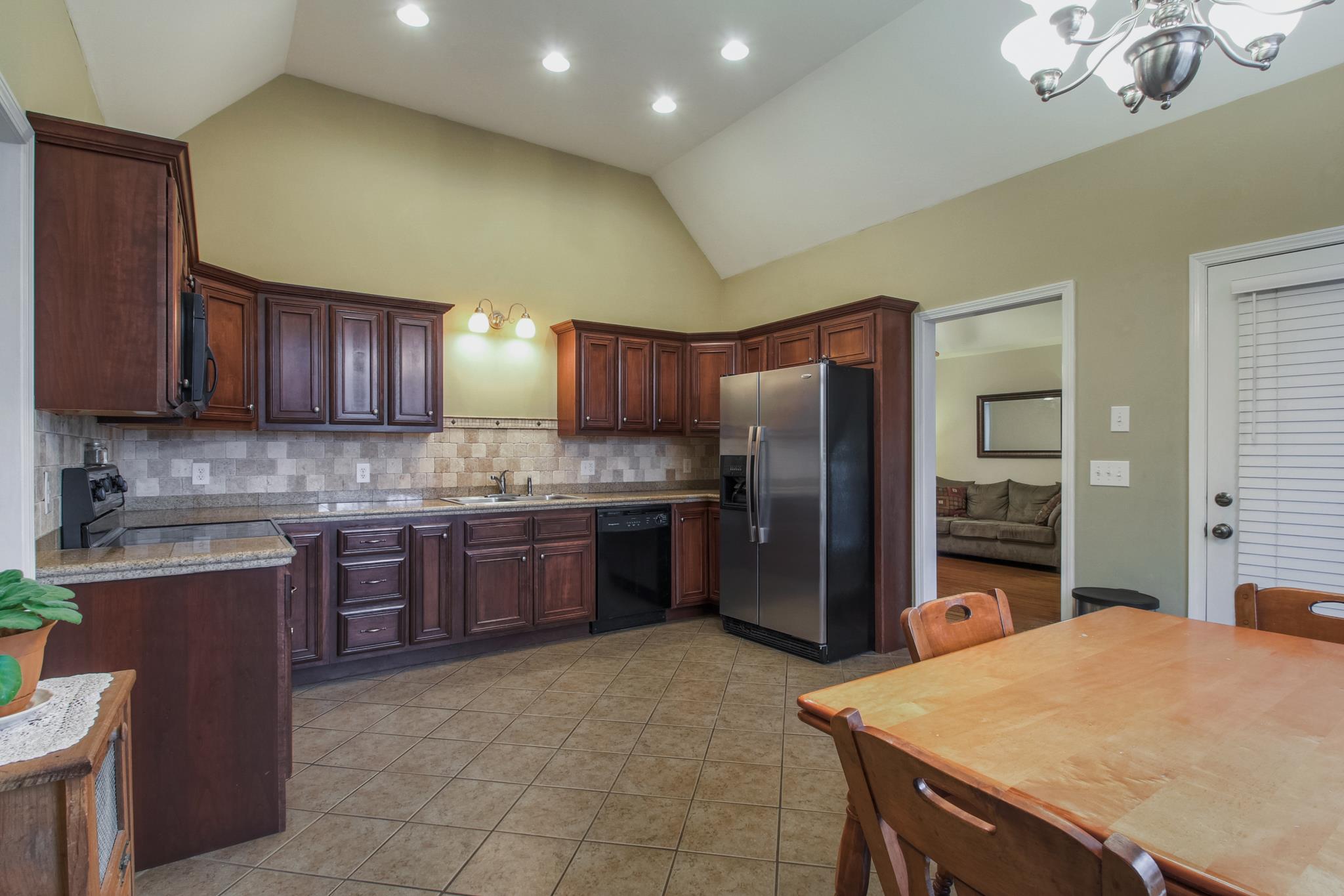 2735 Derby Run Road Springfield, TN 37172 - Photo 5 of 25 a kitchen with stainless steel appliances granite countertop wooden cabinets a refrigerator a stove a sink and dishwasher