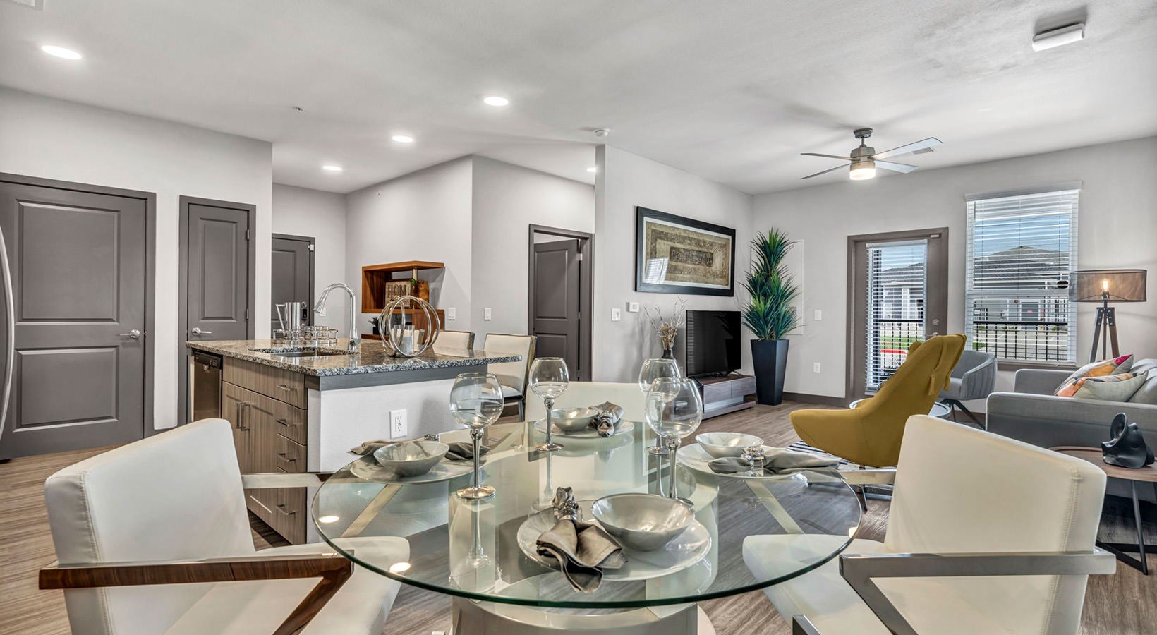 8811 Fm Road, Unit 2303 Richmond, TX 77407 - Photo 2 of 11 a dining room with furniture a kitchen view and wooden floor