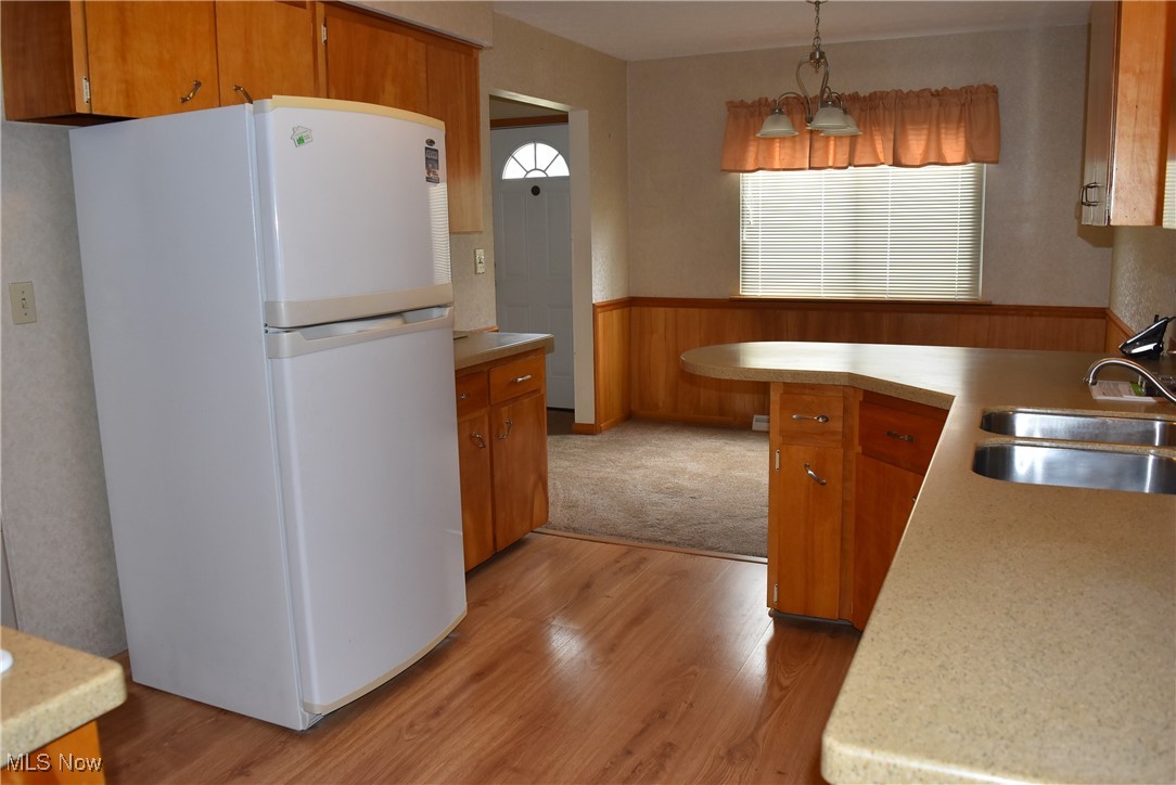 608 Gibbs Road Akron, OH 44312 - Photo 22 of 40 Kitchen with light hardwood / wood-style flooring, sink, pendant lighting, and white refrigerator