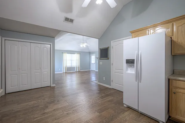 a view of a refrigerator in kitchen and wooden floor