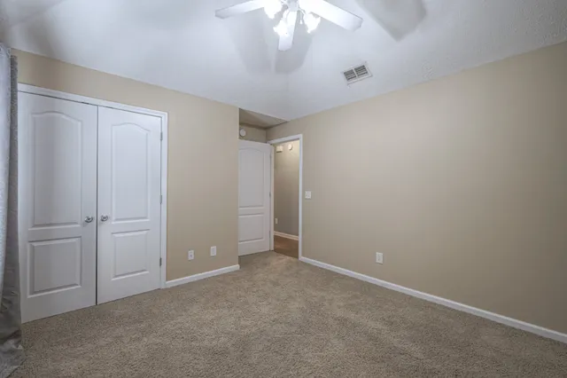 an empty room with closet area