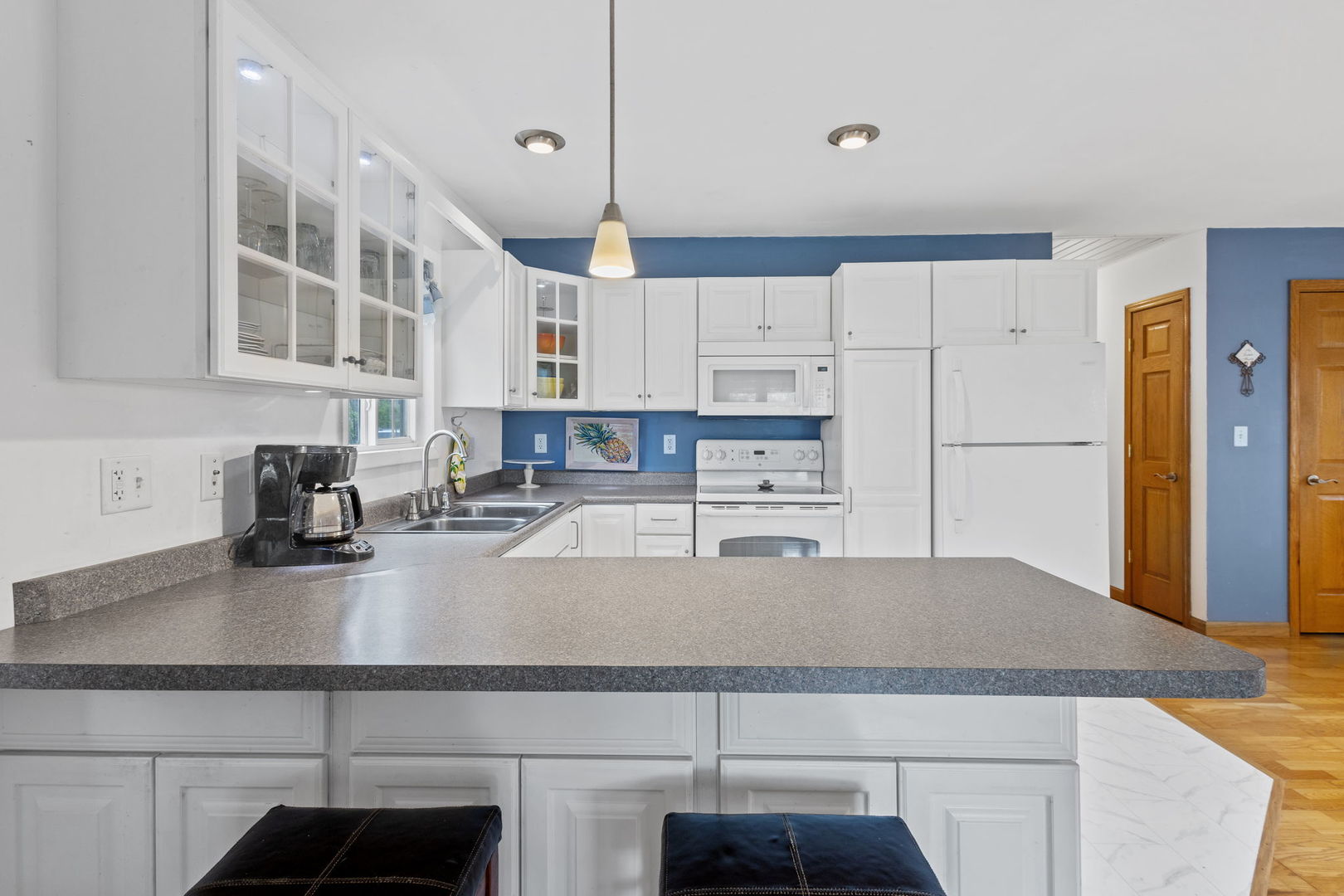 7134 North Bull Creek Road Grant Park, IL 60940 - Photo 21 of 46 a kitchen with kitchen island a sink a stove and white cabinets
