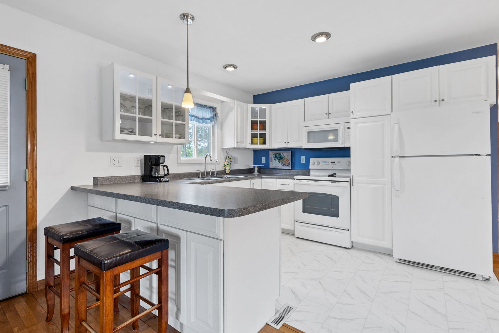 7134 North Bull Creek Road Grant Park, IL 60940 - Photo 22 of 46 a kitchen with white cabinets and white appliances