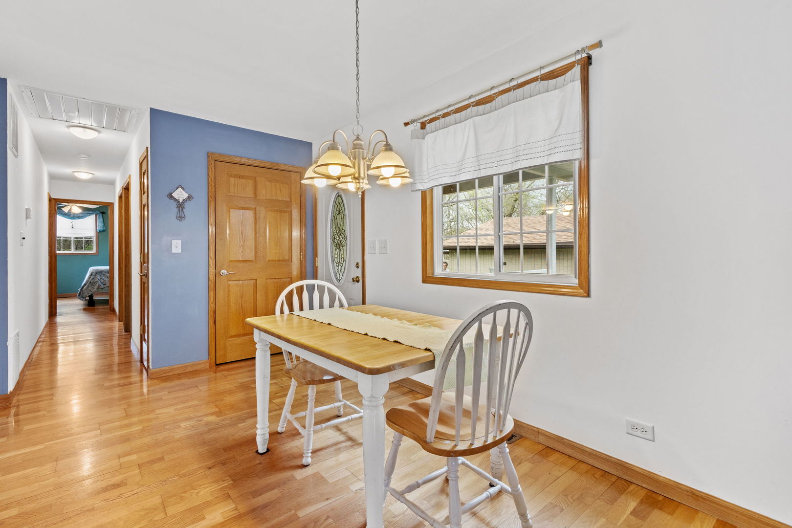 7134 North Bull Creek Road Grant Park, IL 60940 - Photo 28 of 46 a dining room with furniture a chandelier and wooden floor