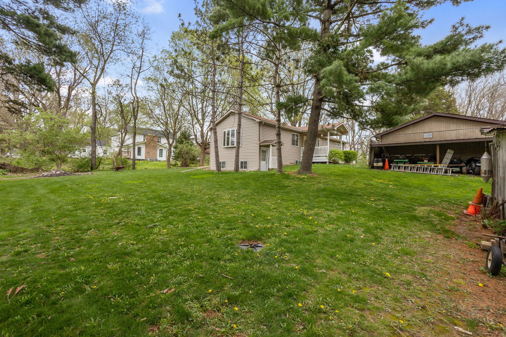 7134 North Bull Creek Road Grant Park, IL 60940 - Photo 4 of 46 a view of a house with a big yard and large trees